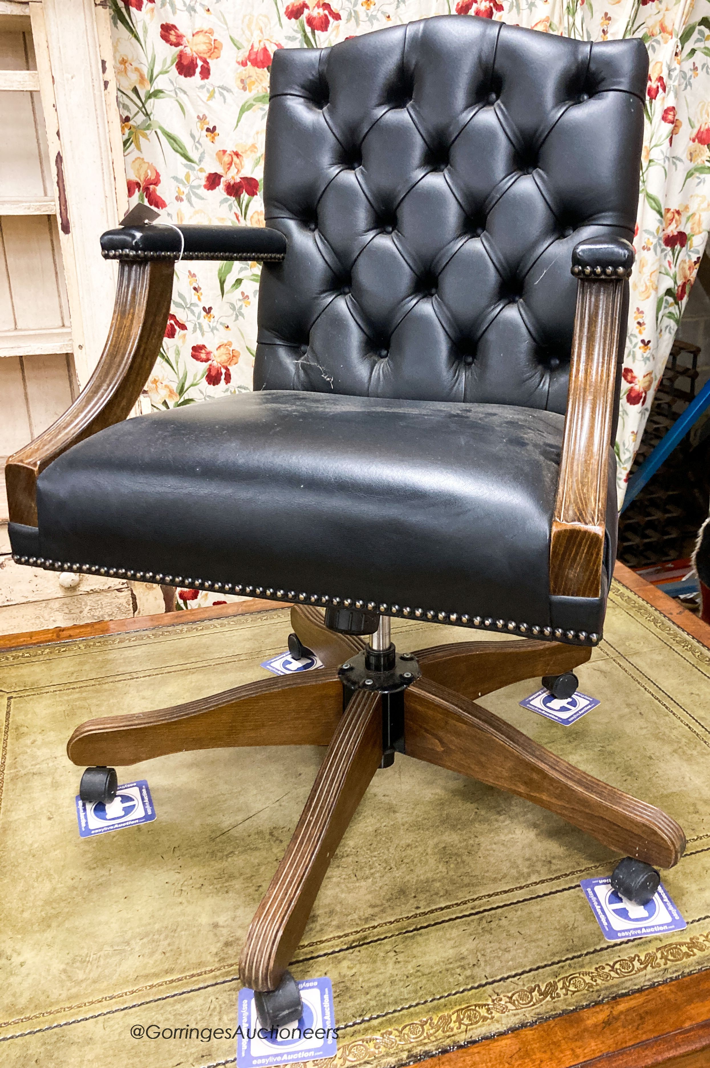 A reproduction beech buttoned blue leather swivel desk chair, W.54cm. D.61cm H.99cm